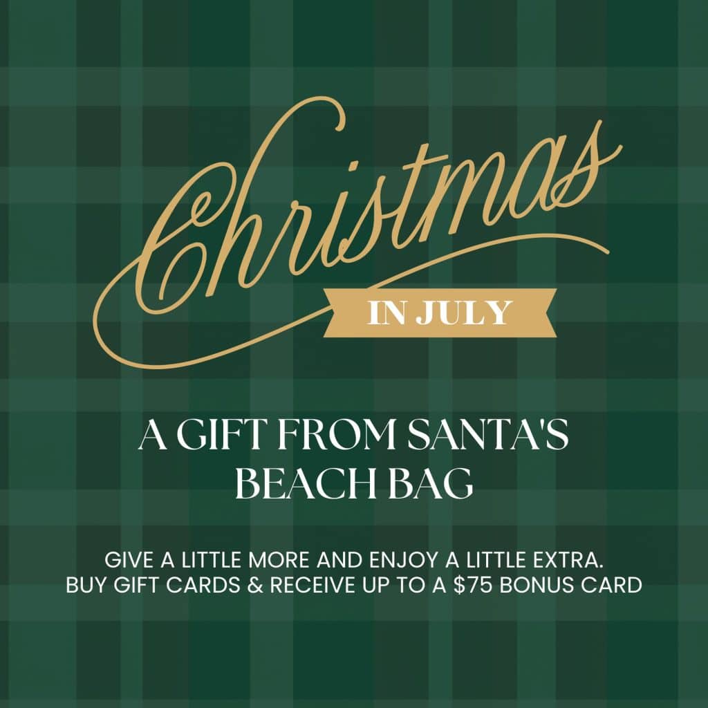 Promotional poster with gold script 'Christmas' and banner 'In July' on a dark green plaid background, advertising gifts from Santa's beach bag.